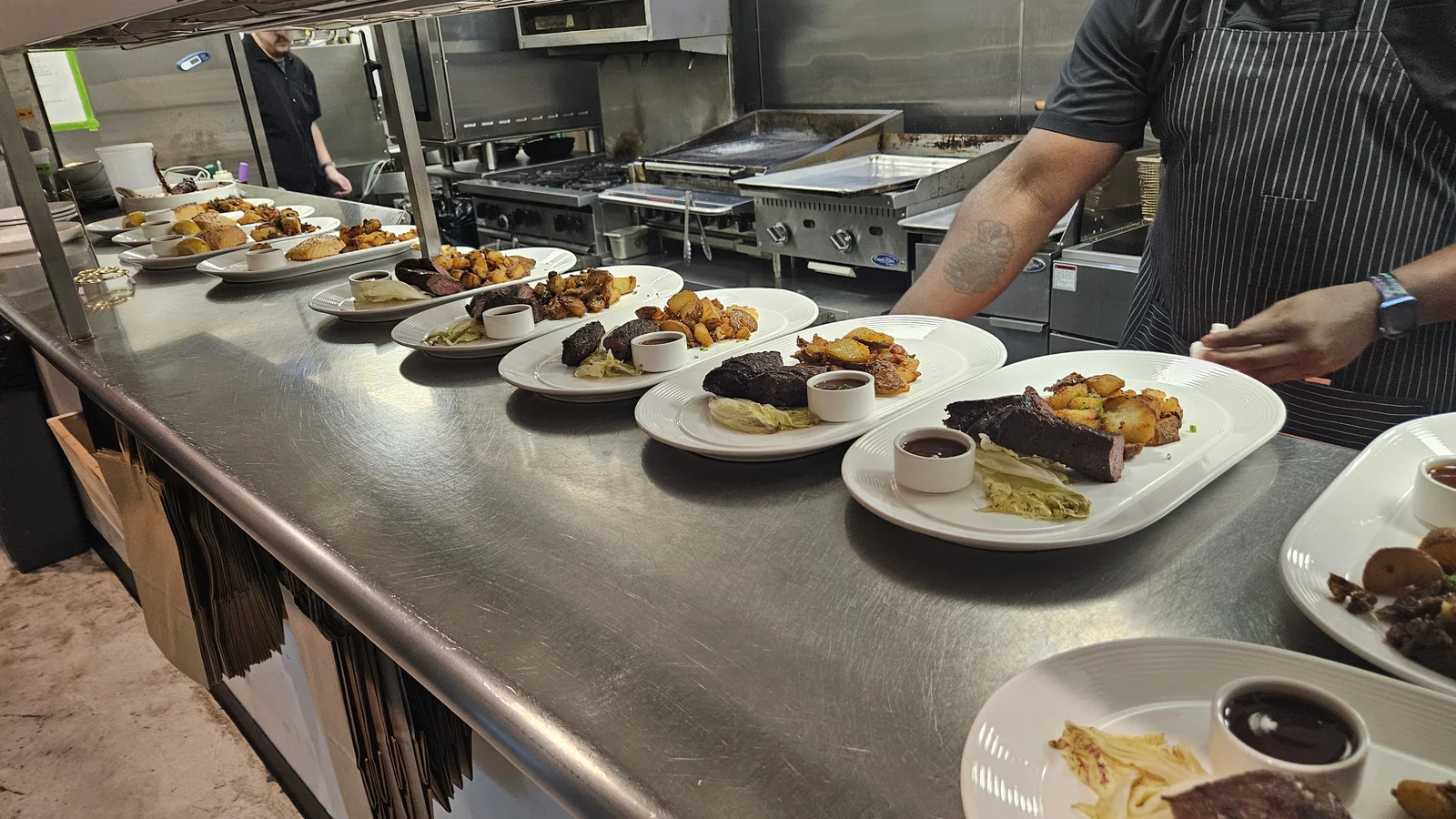 The main course at the benefit dinner: hanger steak with bistro sauce, radicchio and smashed crispy potatoes, plated and ready to go out.